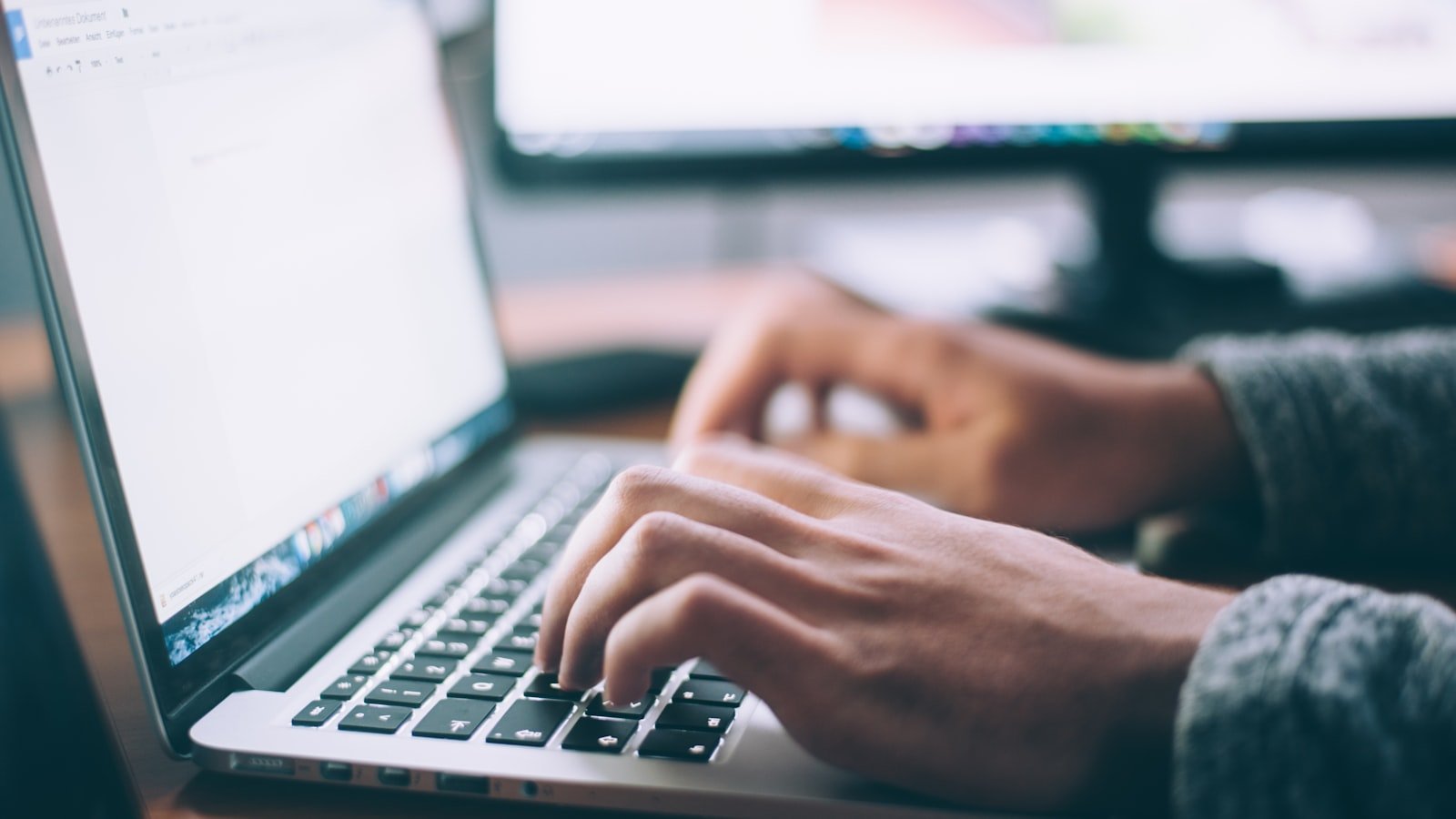 Person typing a friendly message on a laptop