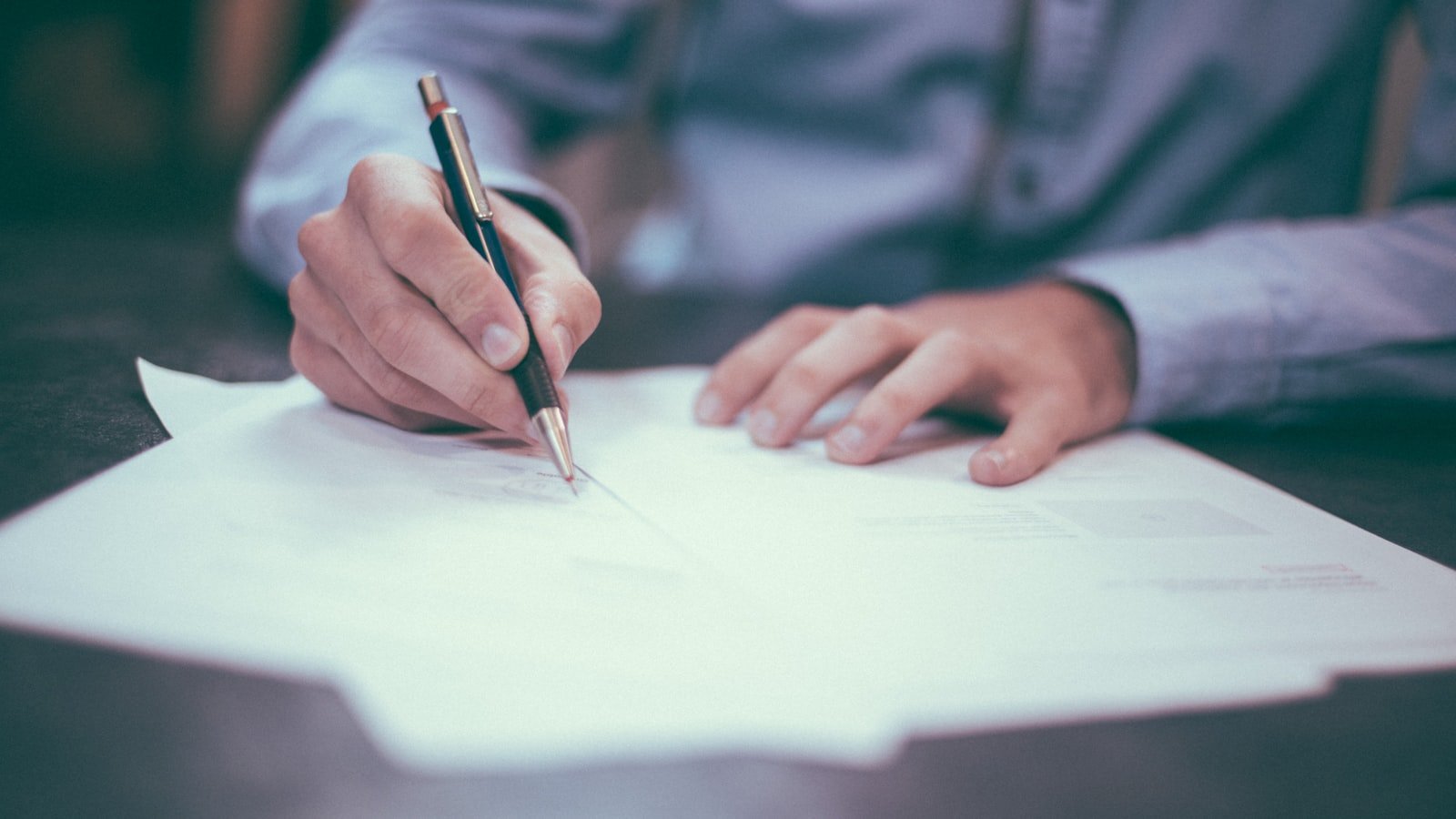 Legal documents and a pen on a desk